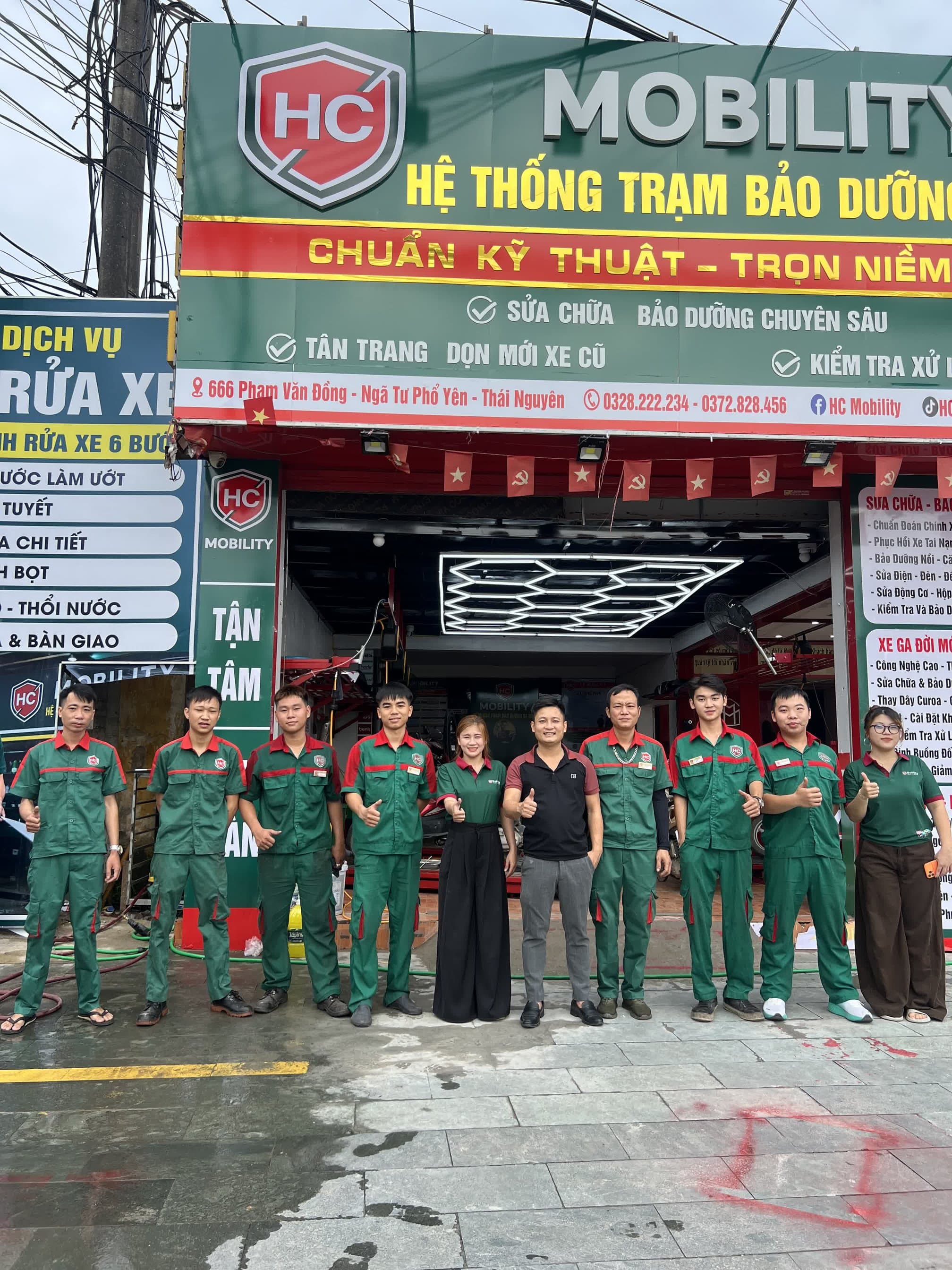 Đội ngũ kỹ thuật viên HC Mobility trước cửa hàng